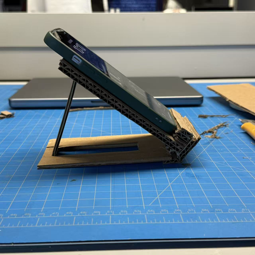 The phone stand with the angle that shows at the side, there's a stand at the back that holds the phone stand by stucking the stand with the holes at phone stand's back.